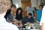Jon Johnson cuts foil for paddle as Professor Bortoletto and colleagues overlook.