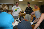 Rob Spencer and Professor Jones watch as Bruce Ryan tests for leaks.