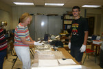 Cheryl McLean and Marla Glover's high school son, Michael, helping to construct a paddle.