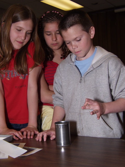 Newton's First Law of Motion can be demonstrated with a soup can, index card, and quarter.