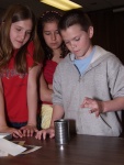 Newton's First Law of Motion can be demonstrated with a soup can, index card, and quarter.