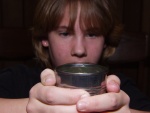 Warm air rises.  This is a principle of convection currents.  When a can, cold from the ice chest, is dipped into soapy detergent, and the can is then warmed, the warm air rises to form the bubble.