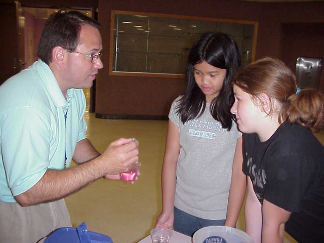 Greg is demonstrating that when soap is added, the surface tension is weakened