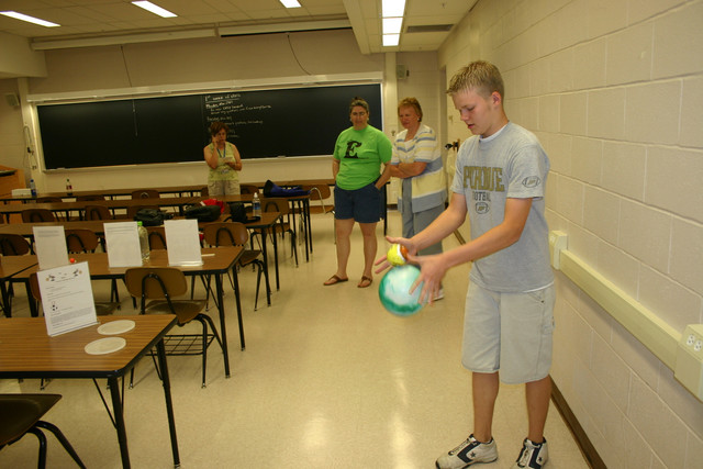 What's the effect from momentum when two balls are dropped simultaneously?  