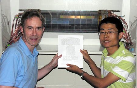 Prof. Ian Shipsey and Graduate Student Bo Xin pose in front of the Si3 silicon detector