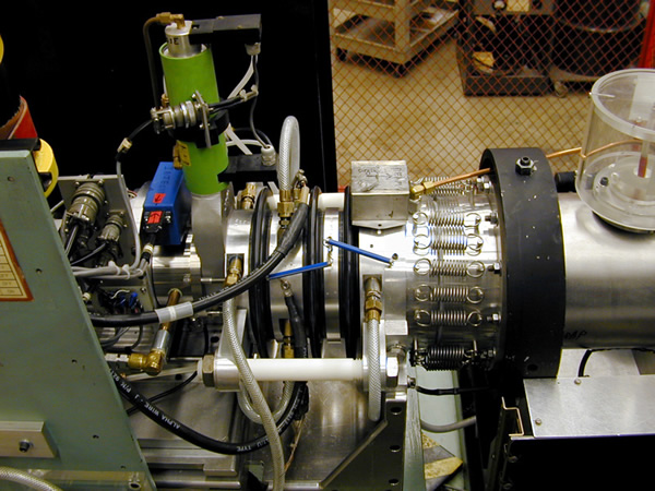 PRIME Lab's old 846 ion source showing from the left: vacuum lock gate valve (green), cathode insulator (black), double extraction insulators, springs on rotable beam-steering flange.