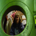 Jane Einstein looking through the tank entrance. Jordan Heim is behind her in the red stripped shirt.