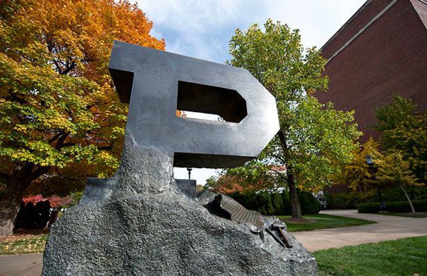 The Block P sculpture with fall trees.