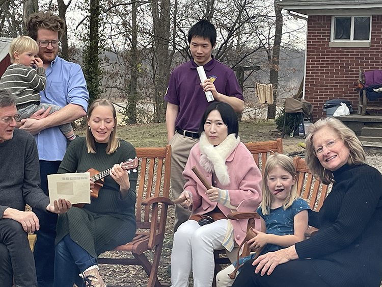 JJ, pictured above in a pink coat, is surrounded by her lab-mates and Professor Koltick’s family at one of the visits to the Koltick family farm. Professor Koltick, pictured seated above at the left, treats his students like family.
