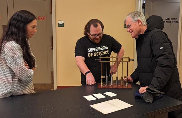 Austin Beidelman (center) and Gary Hudson (right) work together demonstrate the specific heat experiment for Saran Nern, Outreach Coordinator for Purdue Chemistry and co-creator of the Superheroes of Science YouTube channel. Beidelman is a frequent and popular guest on the channel. Photo by Steven Smith.