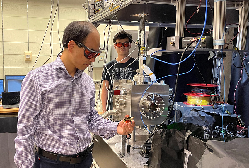 Dr. Tongcang Li holds the gold-film microwave waveguide.