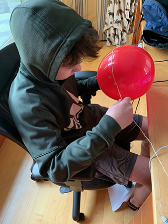 Student working with a balloon.