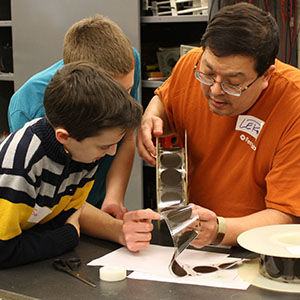 Male students learning about particle physics