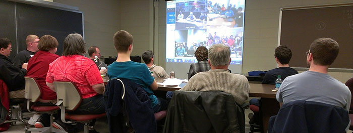 Teachers and students watching a video conference