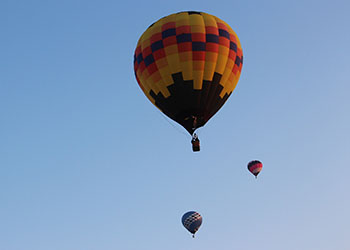 Three hot air balloons in the air
