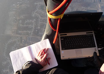 Student taking notes in a hot air balloon