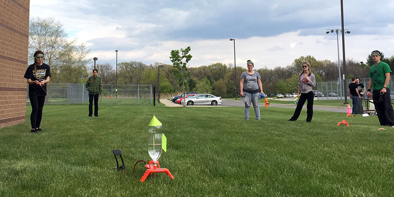 Students analyzing trajectories of rockets